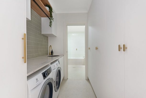 Completed Autograph laundry cabinetry